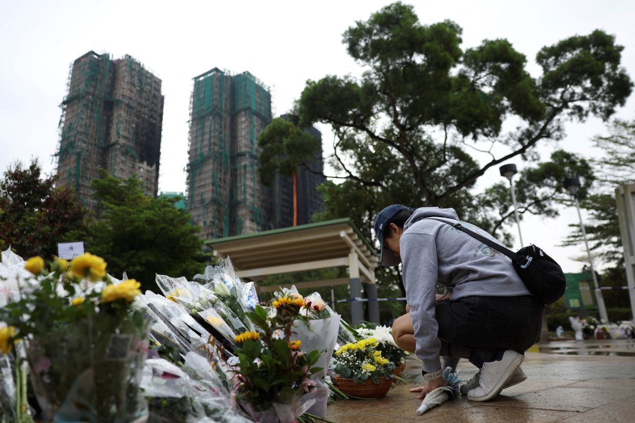Mourners flock to site of deadly Hong Kong blaze as Beijing warns against protests