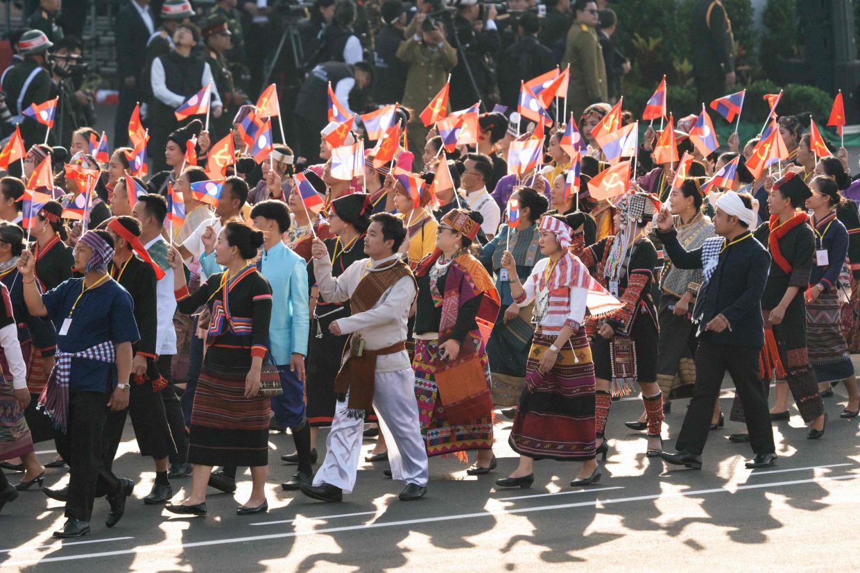 Participants in national attire taking part in a rehearsal on Nov 28 for the Lao National Day military parade on Dec 2. - AFP