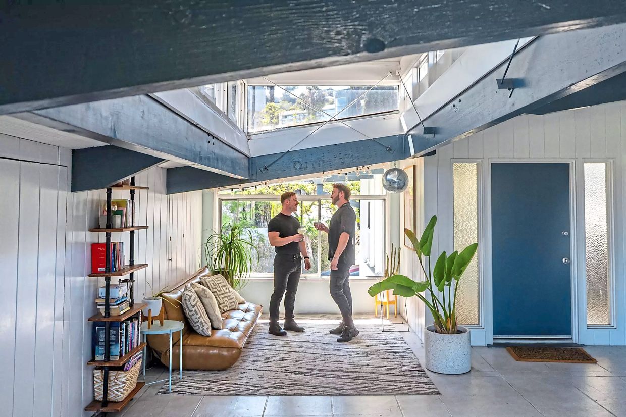 Pina (right) and his friend, Vittorio Manole, stand in the lanai in front of the apartment.