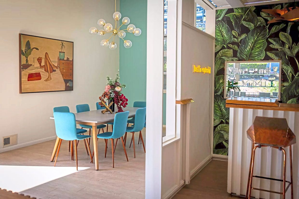 The formal dining room connects to an updated kitchen with stainless steel appliances that faces Sunset Boulevard.