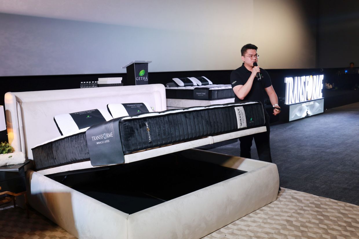 Getha project director Kevin Tan (right) explains to the audience the mechanisms of the new Elevate bed frame that comes with an emergency latch.— KAMARUL ARIFFIN/The Star