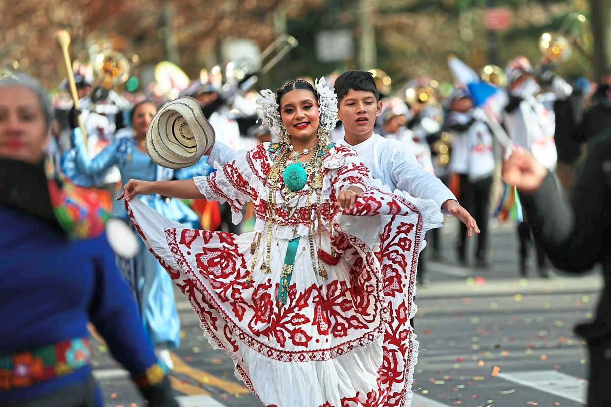 3. A performer in traditional costume taking part in the parade. — Getty Images/AFP