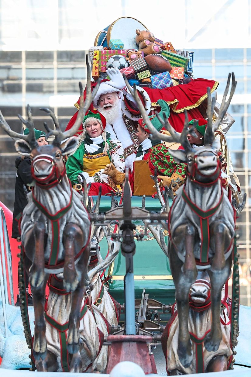 1. Santa Claus and his helpers making their way down the street during the annual Macy’s Thanksgiving Day Parade in New York City. — AFP