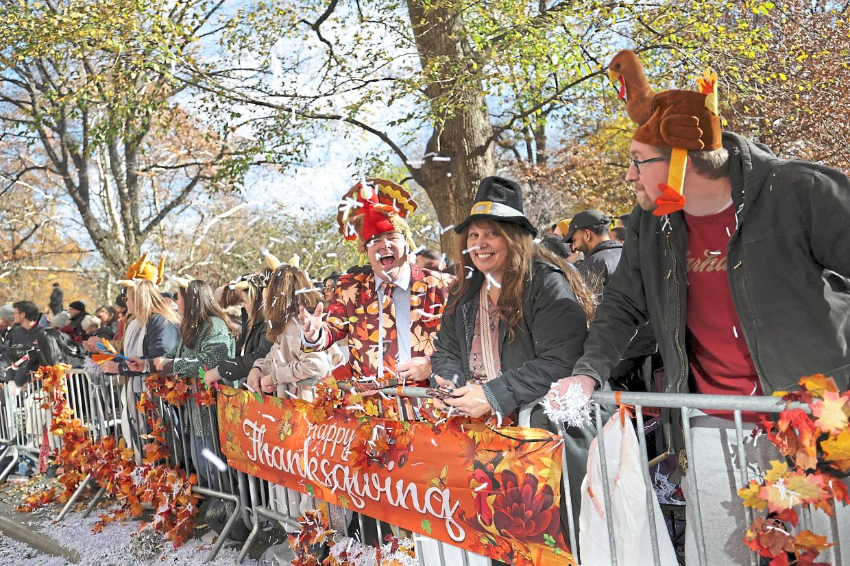 4. Spectators tossing confetti during the Thanksgiving Day Parade in New york City. — Reuters