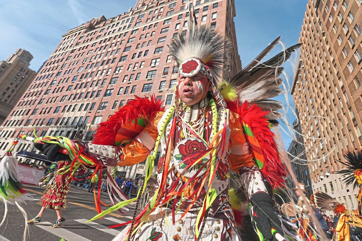 2. A Native Pride Productions performer dancing along central Park West. — AP