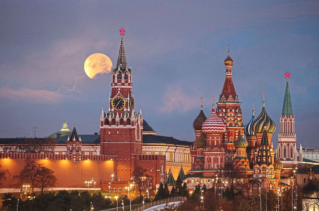 1. The Beaver Moon setting behind the Kremlin and St Basil’s Cathedral in Moscow, Russia — Reuters