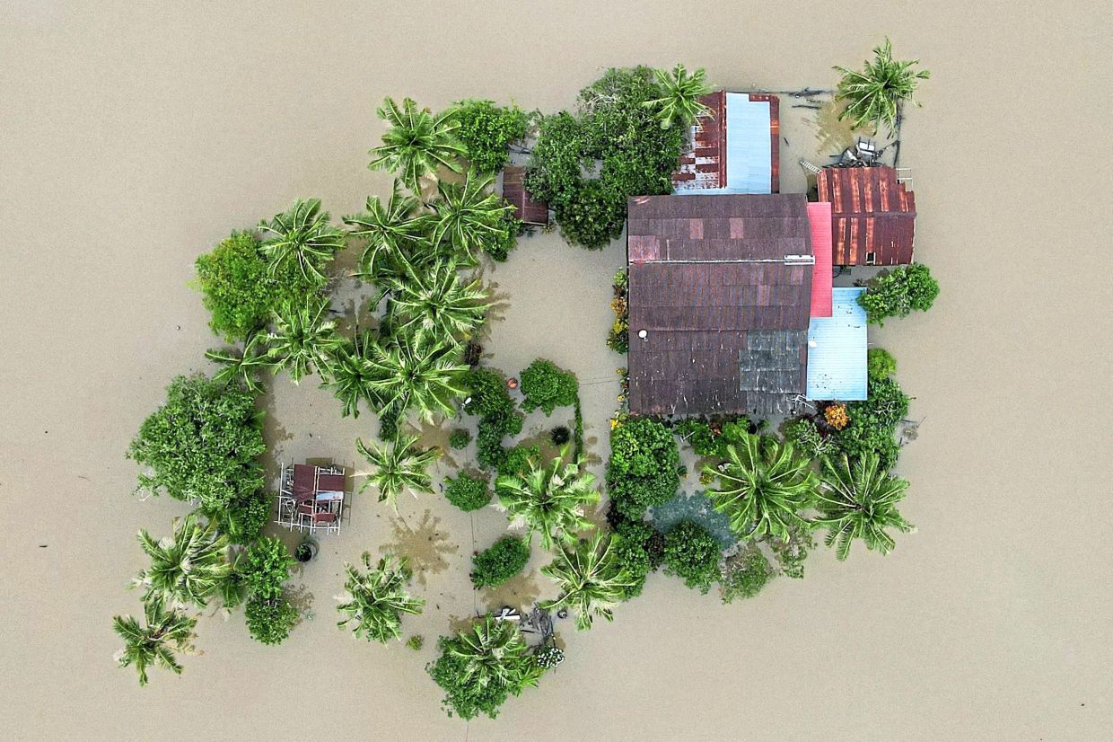 9. Aerial view of a home surrounded by floodwaters in Kangar, Perlis. — AFP