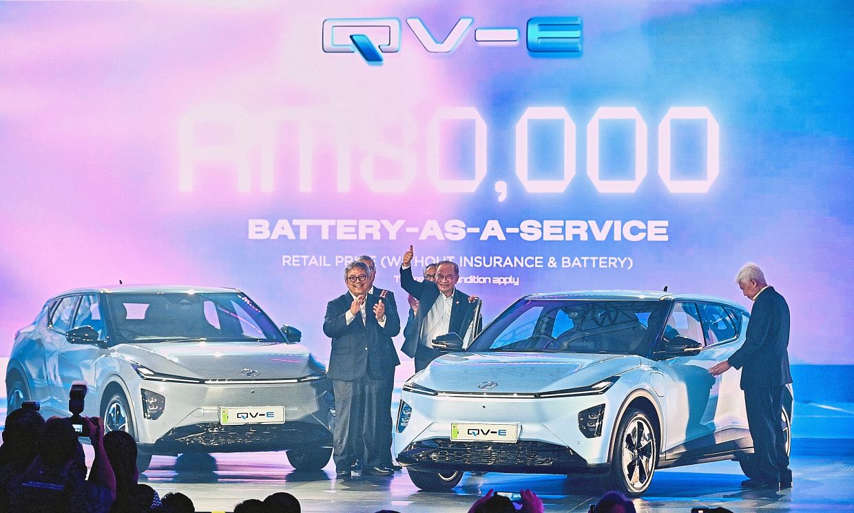 Major milestone: Anwar launching Perodua’s first battery electric vehicle – the QV-E – as part of plans to develop a sustainable EV ecosystem. — RAJA FAISAL HISHAN/The Star