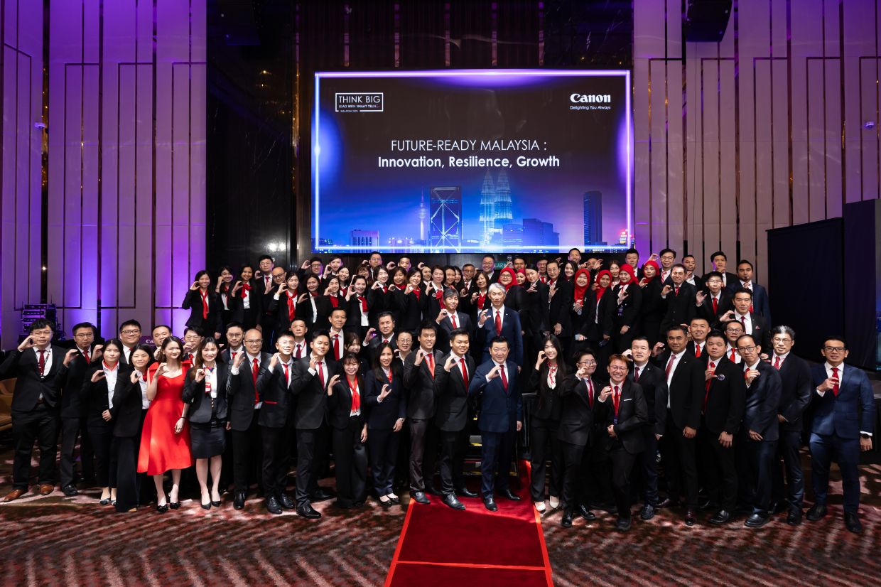 (Front row, centre) Low, with (behind him, in blue suit) Norihiro Katagiri and (on Katagiri’s left) Canon Marketing Malaysia Sdn Bhd president and chief executive officer Masato Yoshiie, together with the Canon Marketing Malaysia team, at the Think Big Klang Valley 2025 Series, showcasing Canon's commitment to Malaysia's digital progress. 