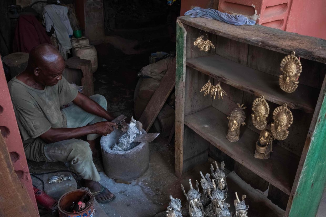 Bronze caster Fred Inneh, 75, chases a piece in his workshop on Igun Street, in Benin City. – Photo: TOYIN ADEDOKUN / AFP