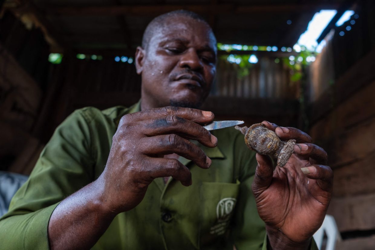 Bronze caster Victor Uyinmwen, 45, works on a piece in his workshop on Igun Street. – Photo: TOYIN ADEDOKUN / AFP