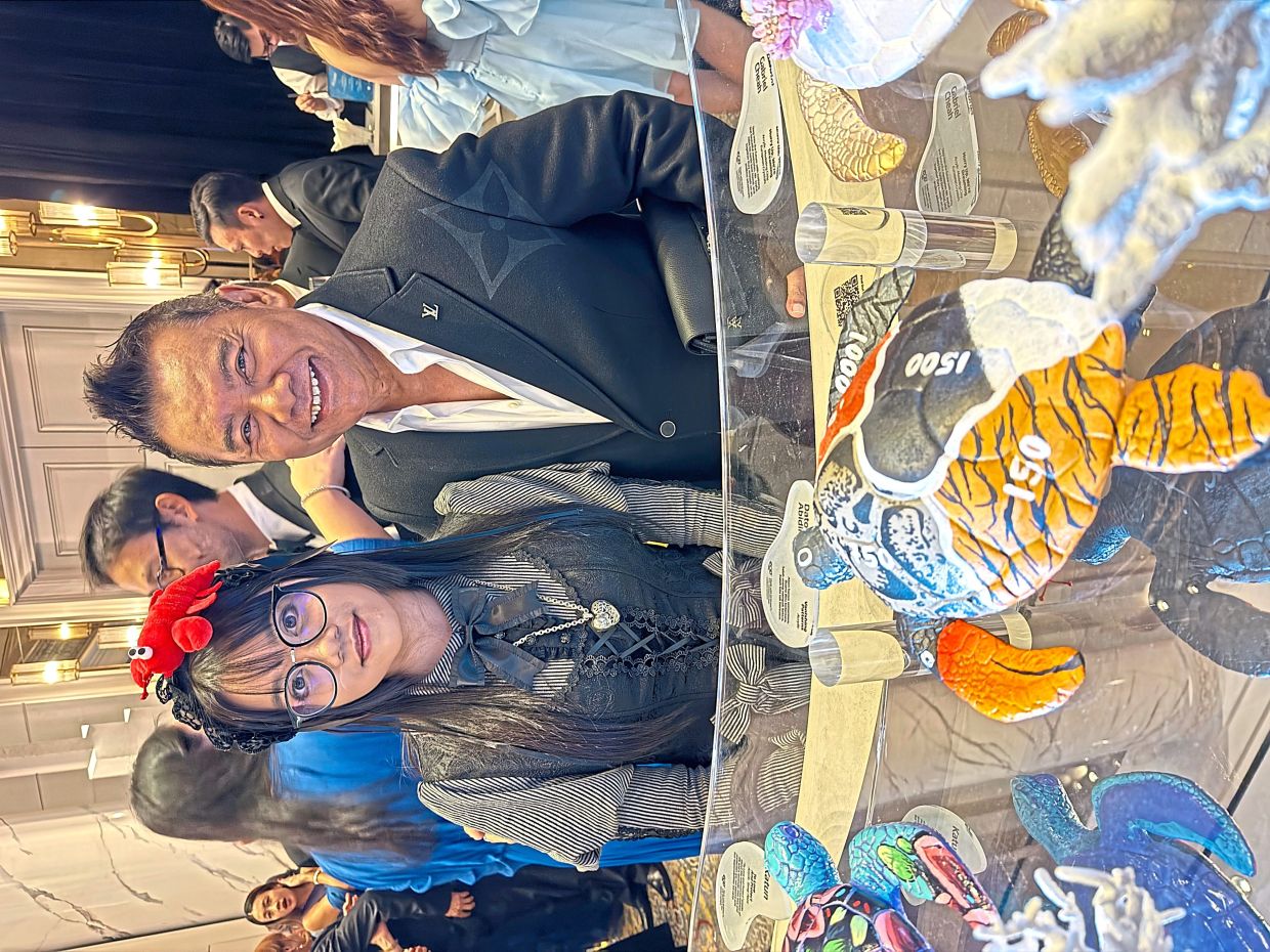 Zainal (right) received the highest bid for a turtle artwork labelled under his name. The singer says the real credit goes to his daughter, Zaara (left).