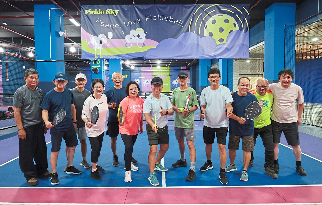 Sim (left) and his former schoolmates from SMK Georgetown meet every week to play pickleball at a mall in Bandar Baru Air Itam, Penang. 