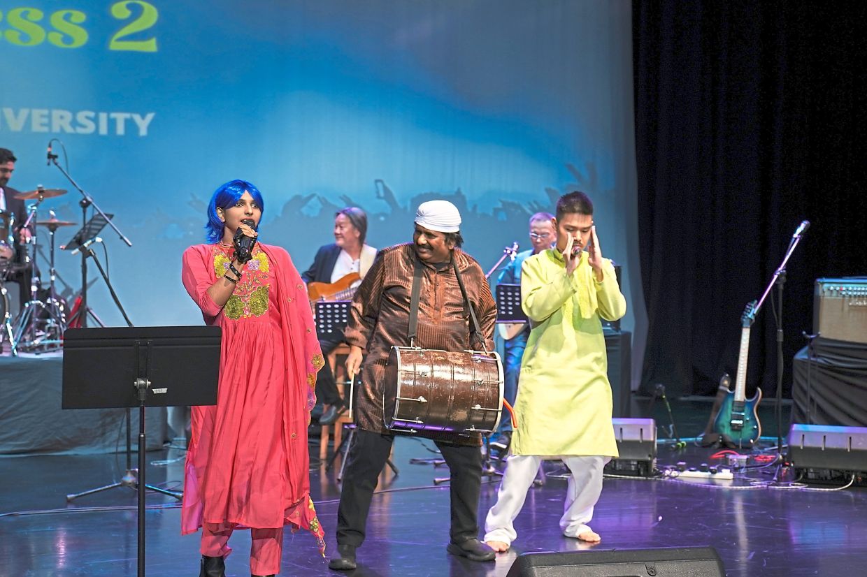 Nathaniel (centre) plays the dhol with neurodivergent performers Nur Shuaibah Ghanim (left) and Salvador Ling.
