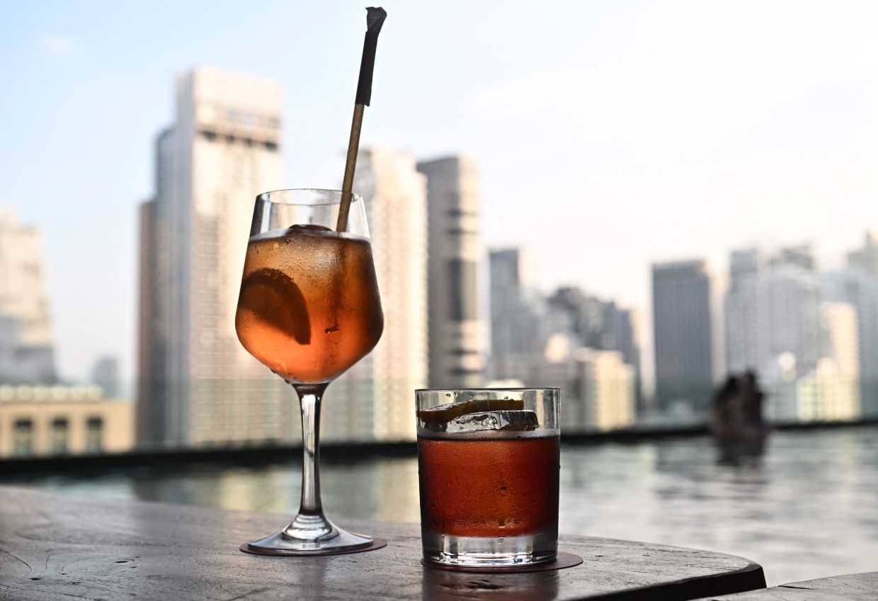 Alcoholic drinks are seen at a rooftop bar in Bangkok Thailand on Dec 3,2025 relaxed decades-old alcohol sales restrictions, allowing consumers to buy wine, beer and spirits during previously prohibited afternoon hours in a six-month trial. - AFP