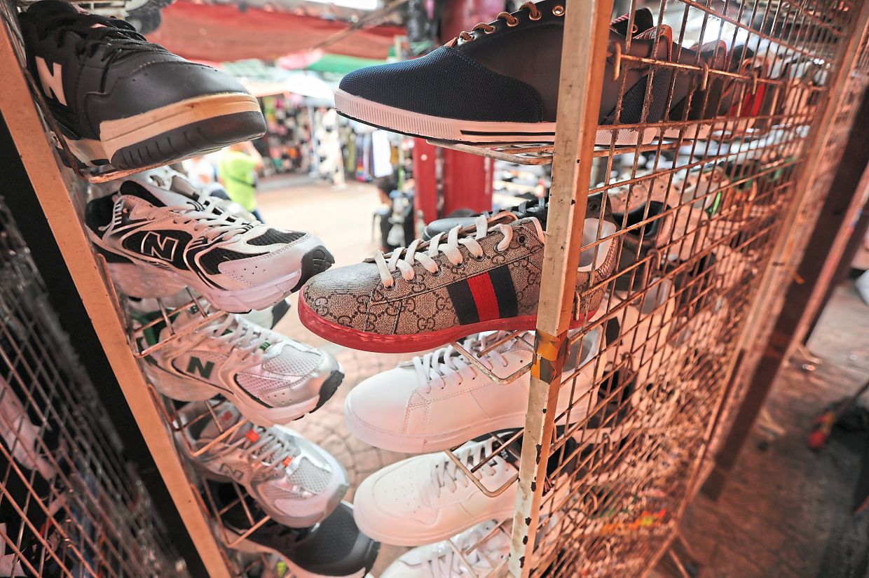 Rows of shoes line the bustling stalls of Petaling Street, tempting shoppers with every style and colour.