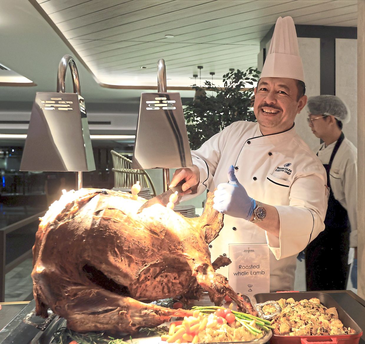 Ridzuan carving up the roasted whole lamb. 