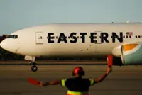 Plane from US carrying returned migrants lands in Venezuela, foreign minister says