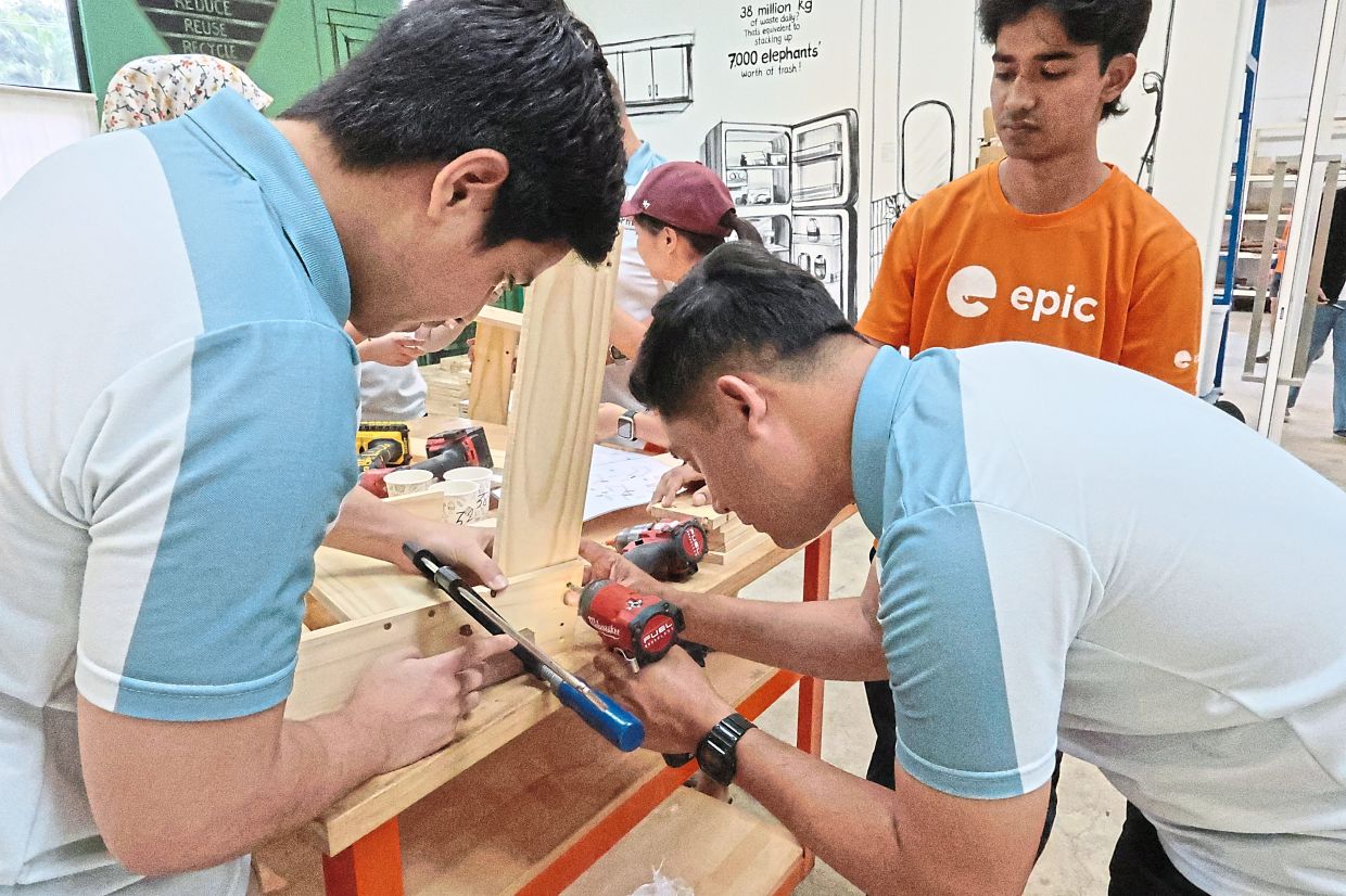PHB staff assembling furniture as part of a teambuilding and volunteer effort. 