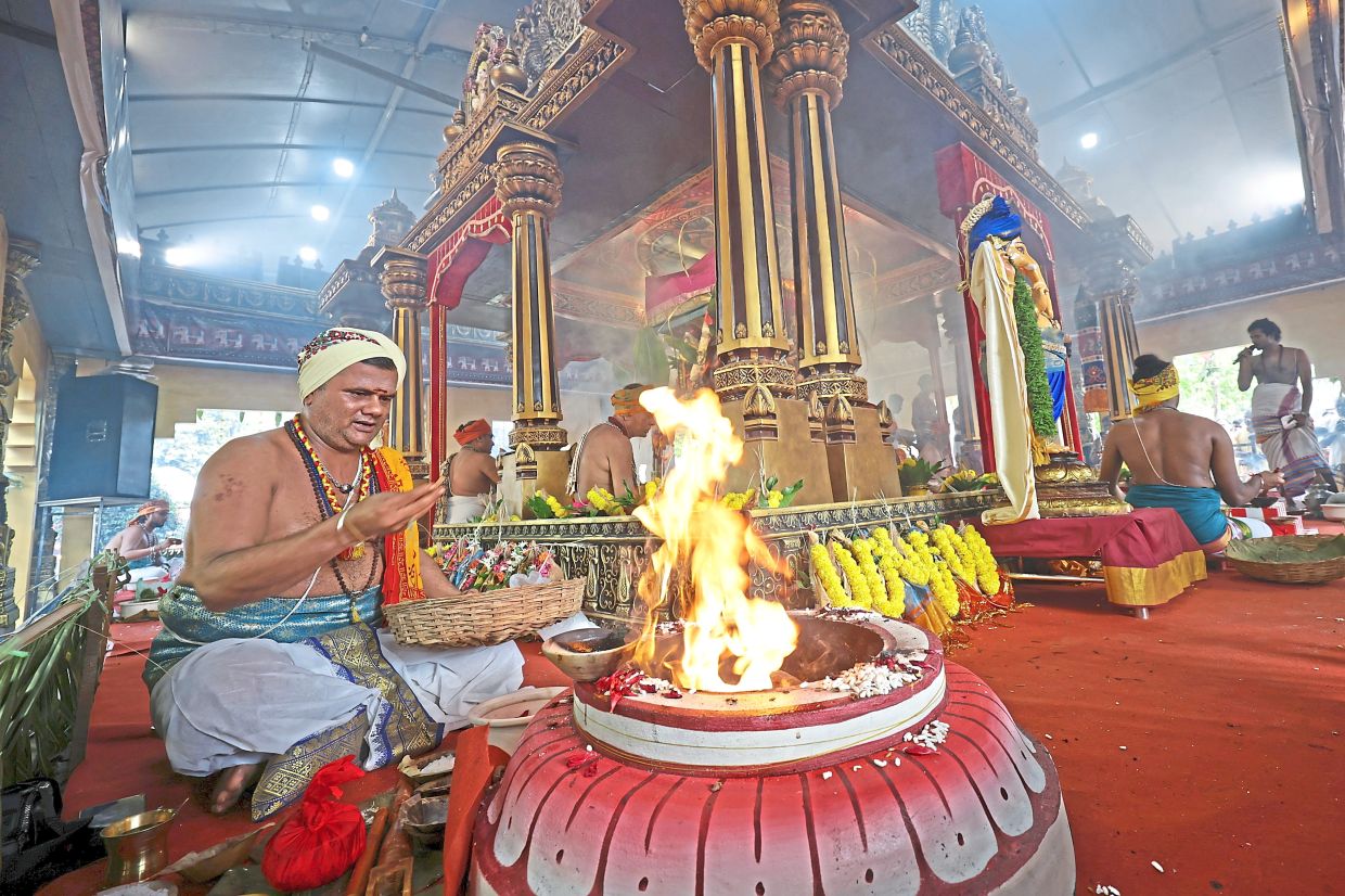 A priest performing rituals ahead of the consecration ceremony in the temple.