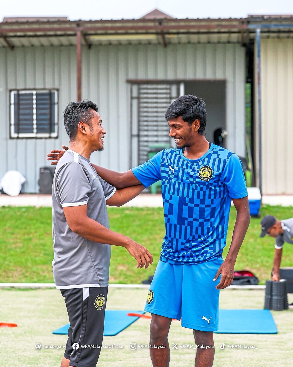 Haziq sharing a light moment with the fitness coach.— FAM