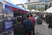 M-cyclists flock to free engine oil change, helmet exchange booths at Madani event