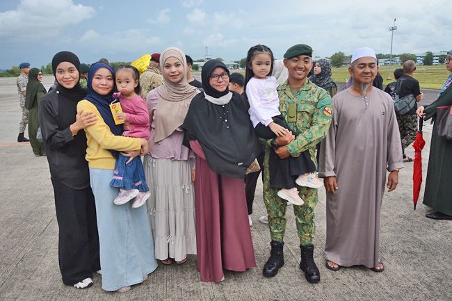 Members of the RBAF contingent and their family members in group photos; and the Royal Brunei Air Force C295MW transport aircraft arrives. - Photo: Borneo Bulletin/ANN