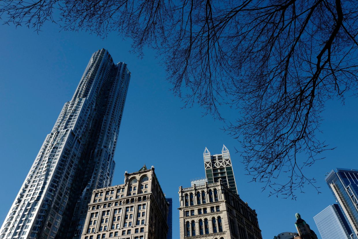 The Beckman Tower, left, designed by architect Frank Gehry towers over older architecture, in New York, March 5, 2018. – AP Photo/Mark Lennihan
