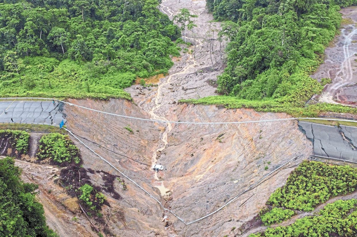 Tragic plunge: An aerial view of the couple’s vehicle after it plunged into the deep ravine along a closed section of Jalan Kuala Jeneris-Sungai Gawi-Aring (Bukit Kawah) in Terengganu. — Bernama