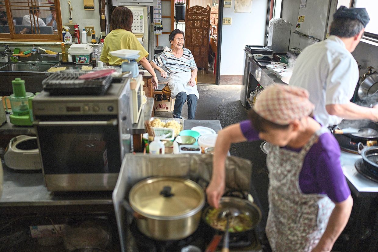 Amakawa, 102 (second from left) says working at the restaurant that she has worked for the last 60 years has improved the quality of her life.