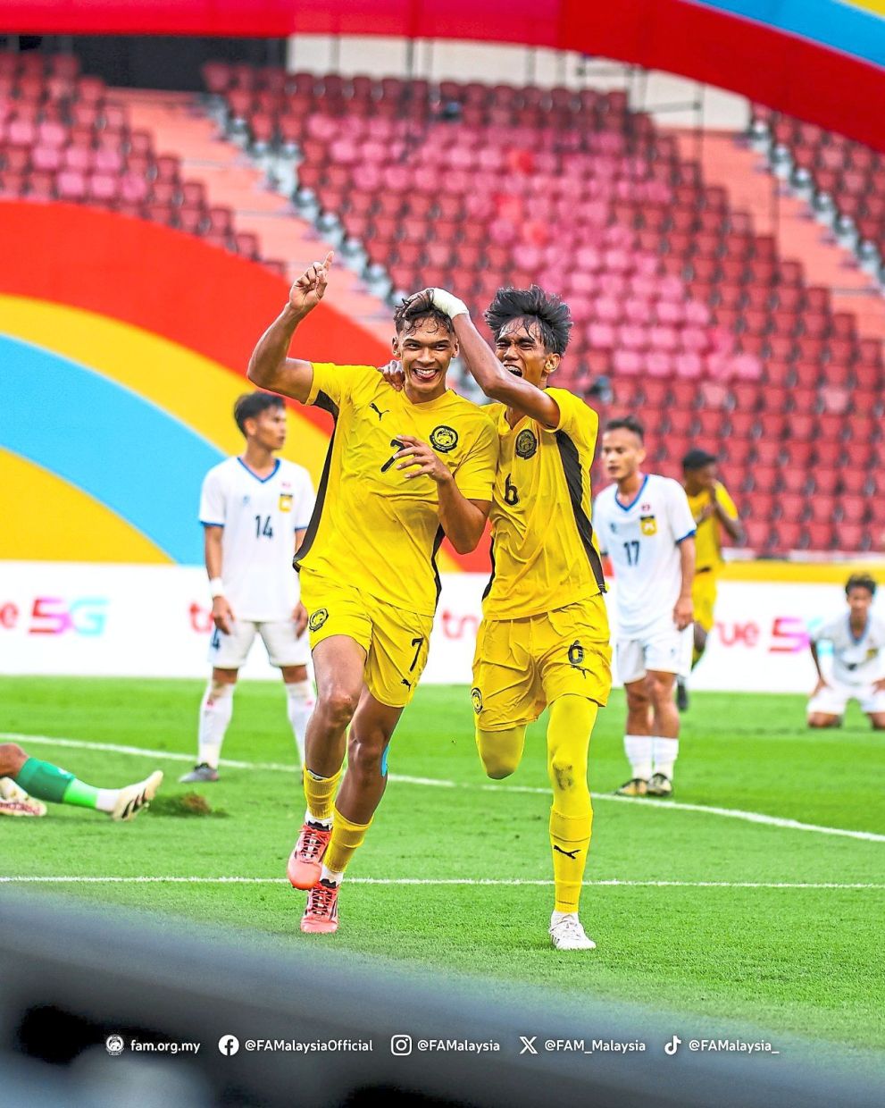 Over the moon: Malaysia’s Haqimi Azim Rosli (left) celebrating after scoring against Laos in the Group B opening match. — FAM