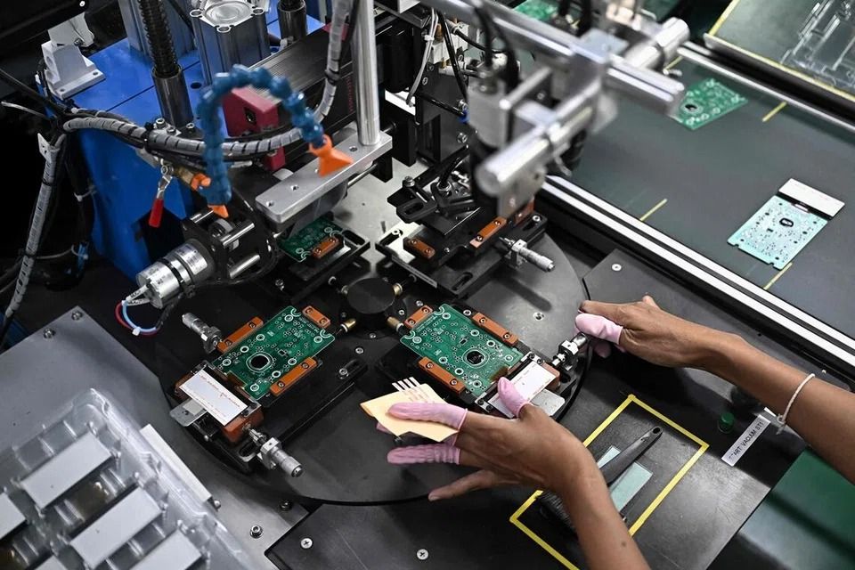 This photo, taken on Nov 12, shows workers assembling calculators at the Casio factory in Thailand’s Nakhon Ratchasima province. --PHOTO: AFP