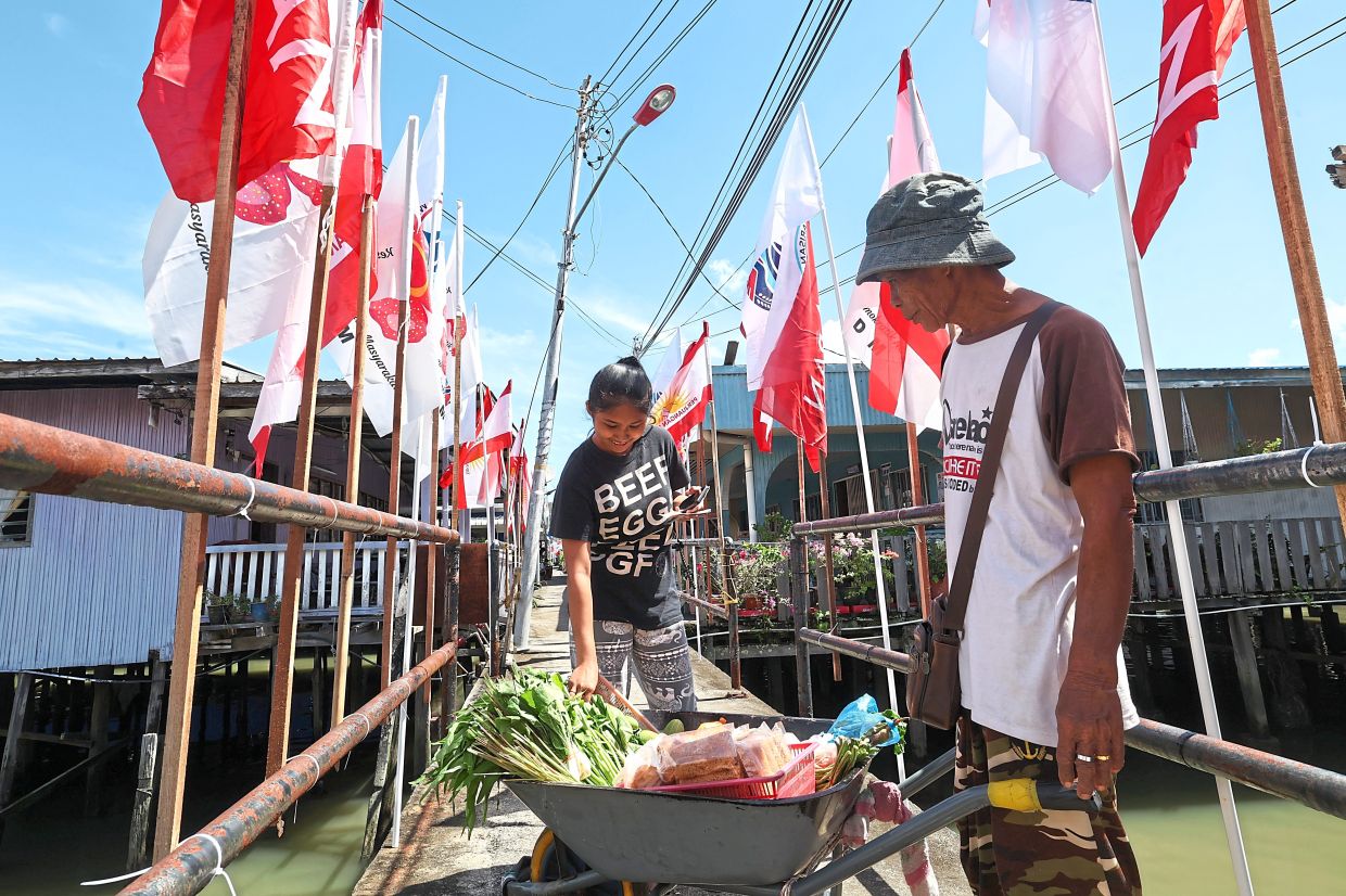 A resident earning a living selling vegetables on a bridge in the village.