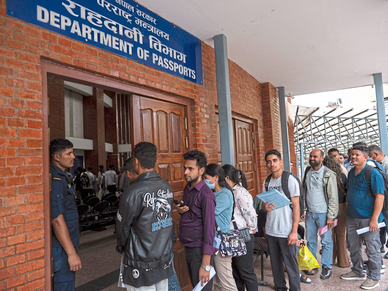 Khatiwada, a Harvard graduate and former Miss Nepal, was among the affluent young Nepalis derided as ‘nepo kids’ before the protests in Kathmandu. (Left) People lining up outside the Department of Passports in Kathmandu. The protests that rocked Nepal were about more than a social media ban. The economy is so dire that for many, going abroad seems the only way to build a future. — Atul Loke/ Uma Bista/The New York Times