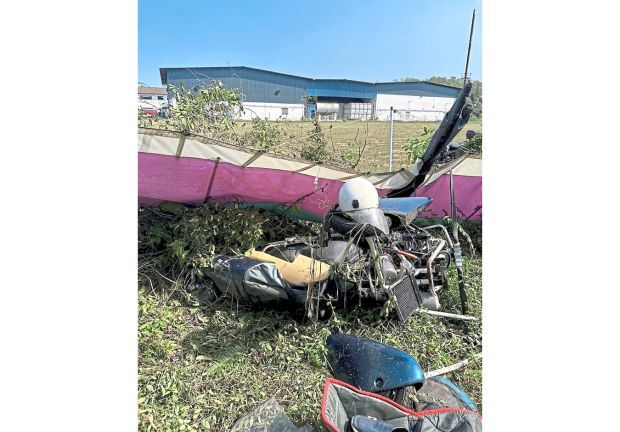 Lucky escape: A light aircraft had to make an emergency landing at an open area near the Tekah airport in Taiping, injuring two men.