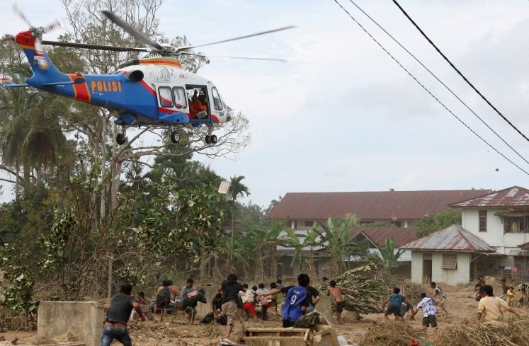 A police helicopter delivering relief supplies for survivors in an area affected by a deadly flash flood in Karang Baru, Aceh on Dec 6, 2025. - Reuters
