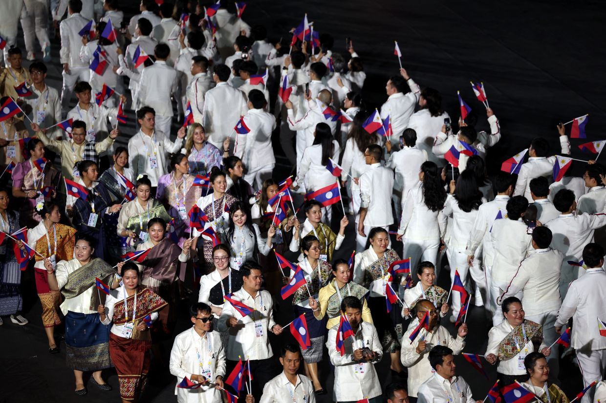 Laos' contingent during the parade of nations at the SEA Games opening ceremony. -- Photo: REUTERS/Chalinee Thirasupa