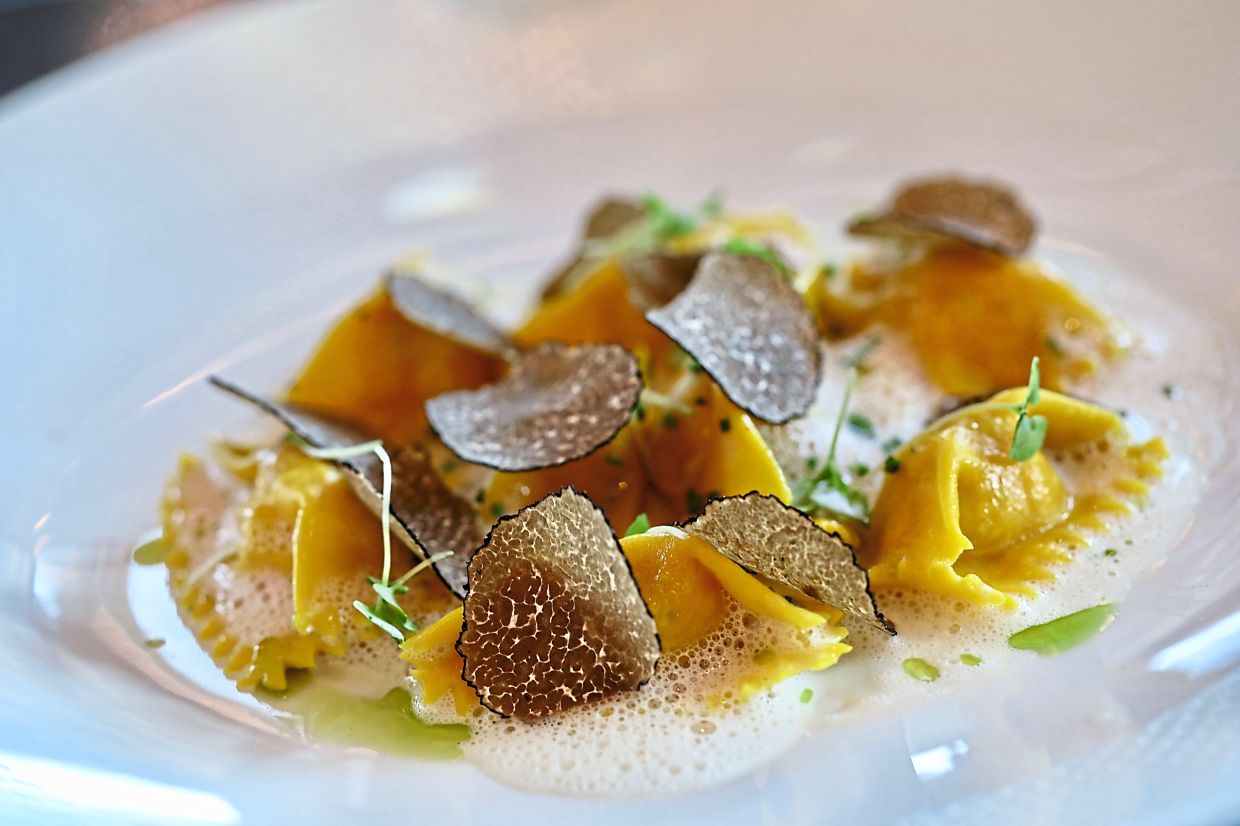 Langoustine Agnolotti is a bisque with black truffle and delightful yellow lobster meat parcels.