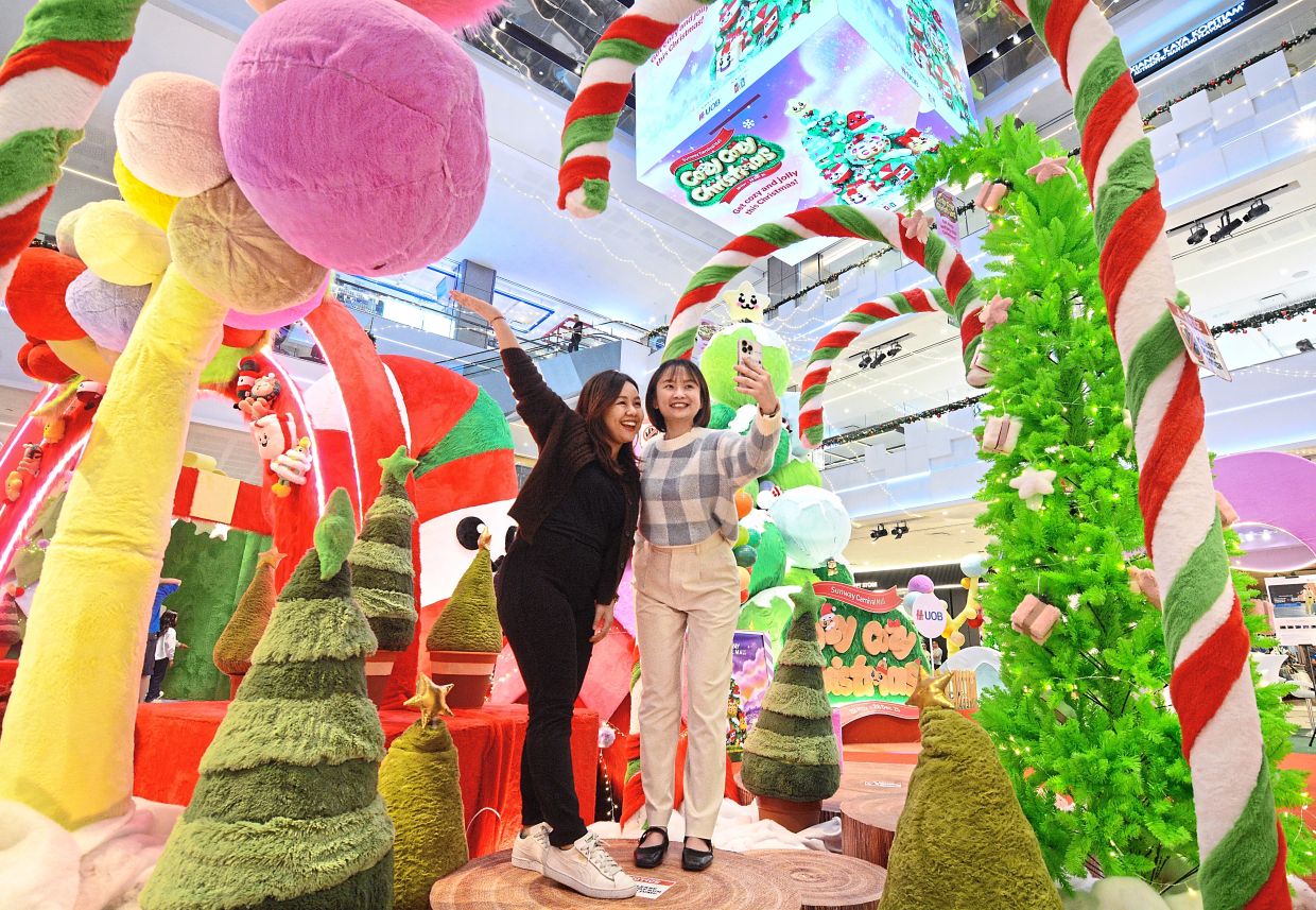 Shoppers taking photos with the large candy canes, fuzzy Christmas trees and fluffy baubles that are part of Sunway Carnival Mall’s magical “Cozy Cozy Christmas” holiday realm.