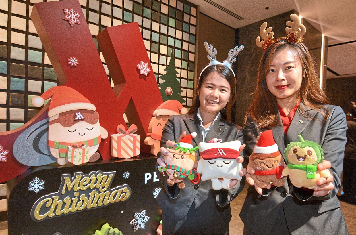 Penang Marriott Hotel staff showing the “Wonderful Buddies” plush keychain Christmas characters (from left) Chendie, Pillo, Chef Coco and Duri.