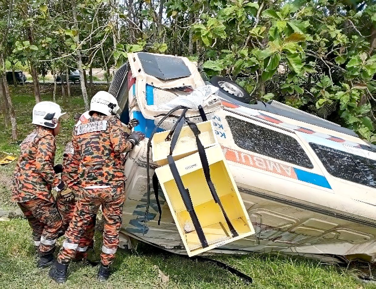 Crash response: Firemen arriving at the scene to carry out rescue work after an ambulance skidded on the North-South Expressway near Kluang.