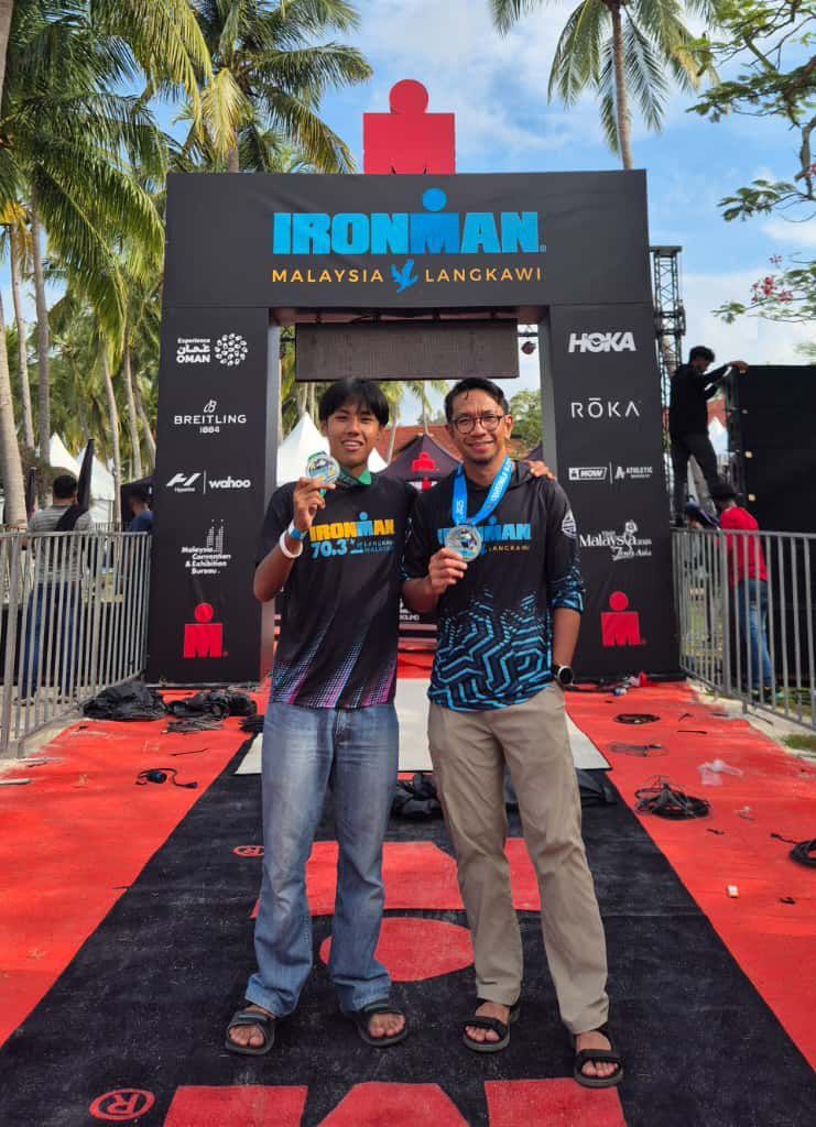 Father and son with their respective Ironman medals.