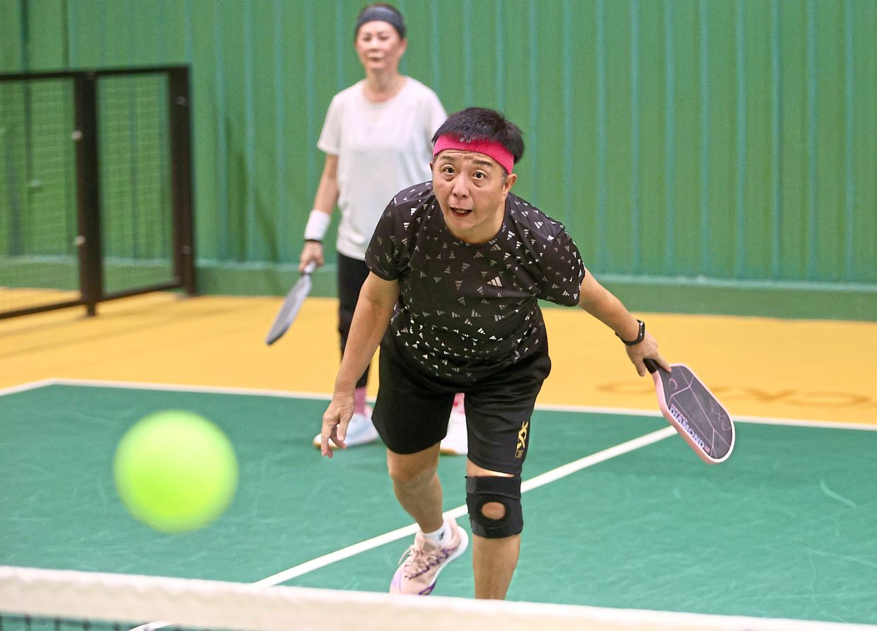 Chia (front) transitioned from playing badminton to pickleball because she says it’s less stress on her knees.