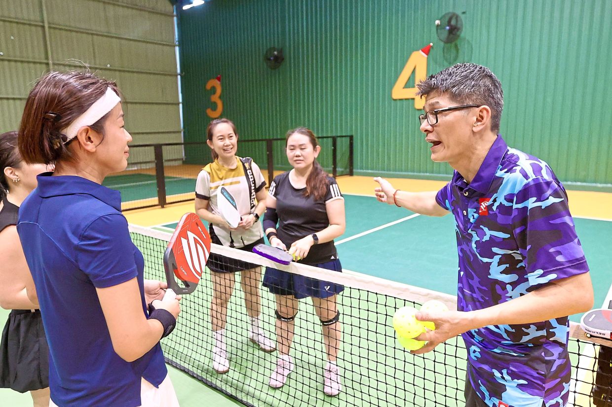 Chan (right) is a veteran racquet sports player for over 20 years. He says the ease of picking up pickleball has bolstered its popularity.