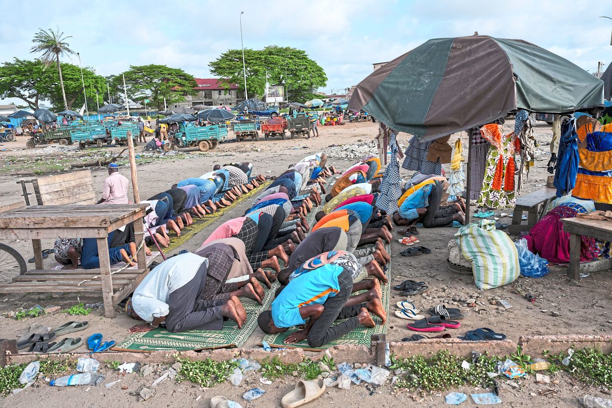People praying near the livestock market.