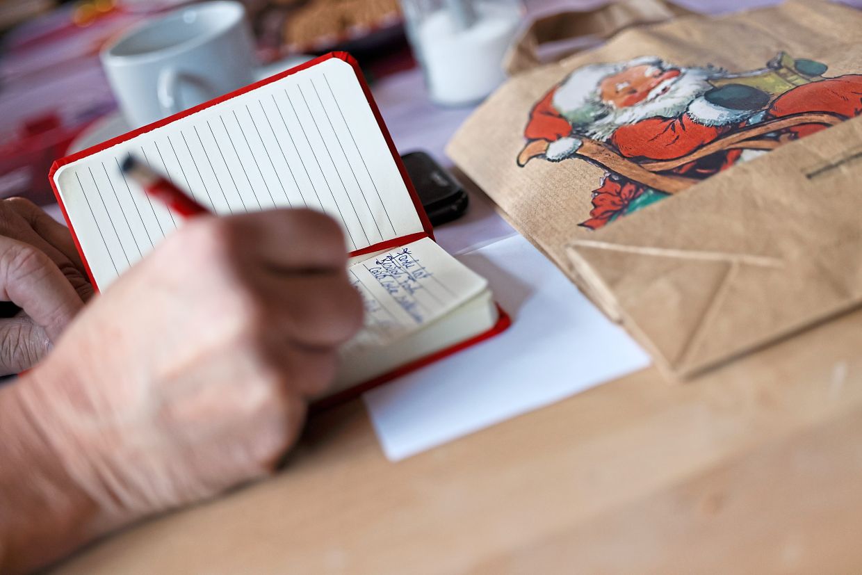 A participant in the Santa Claus training takes notes during the seminar.