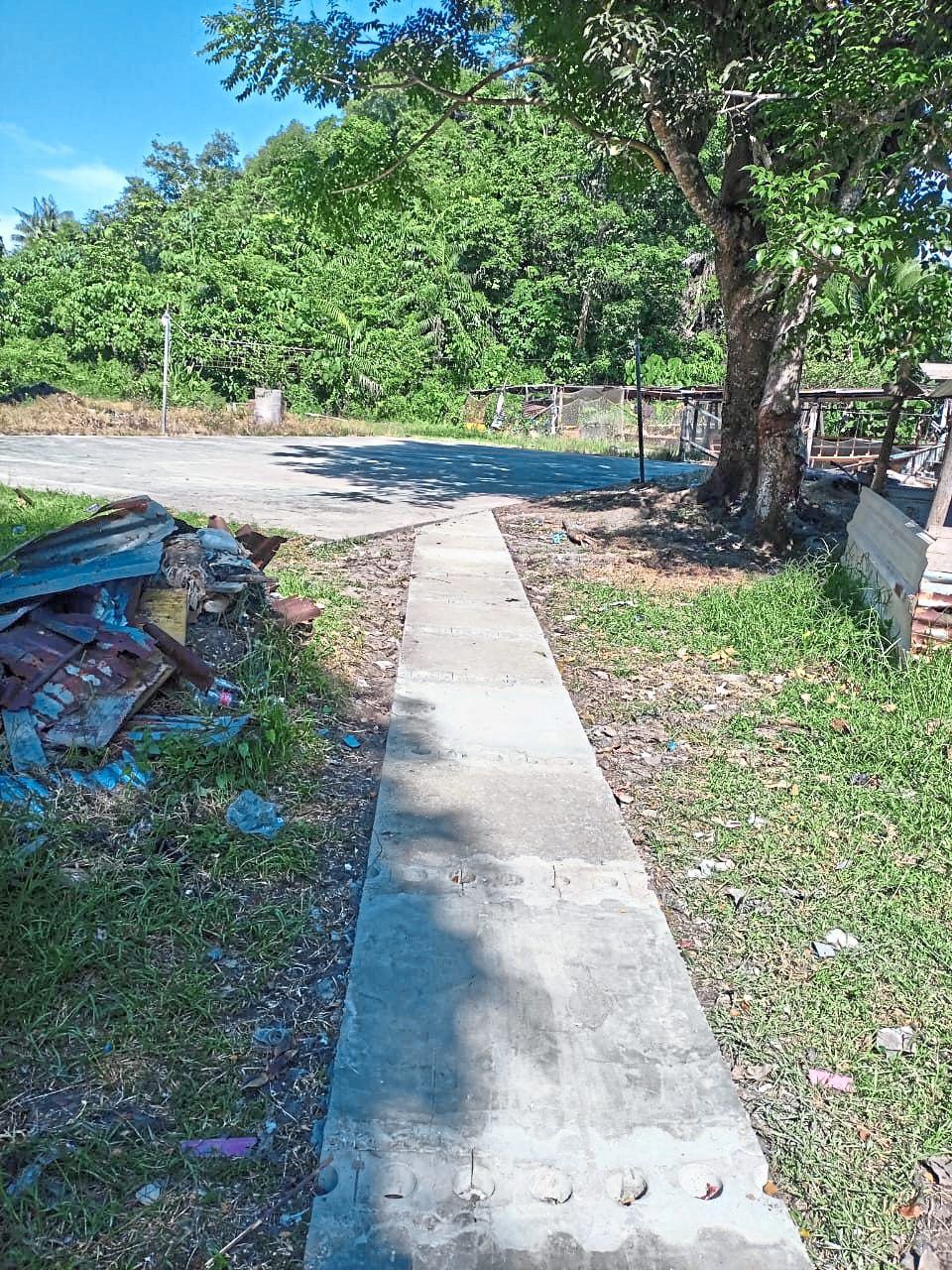 Repurposed plastics: The ocean debris pathway leading to the local sports court in Kampung Lobong on Pulau Gaya.