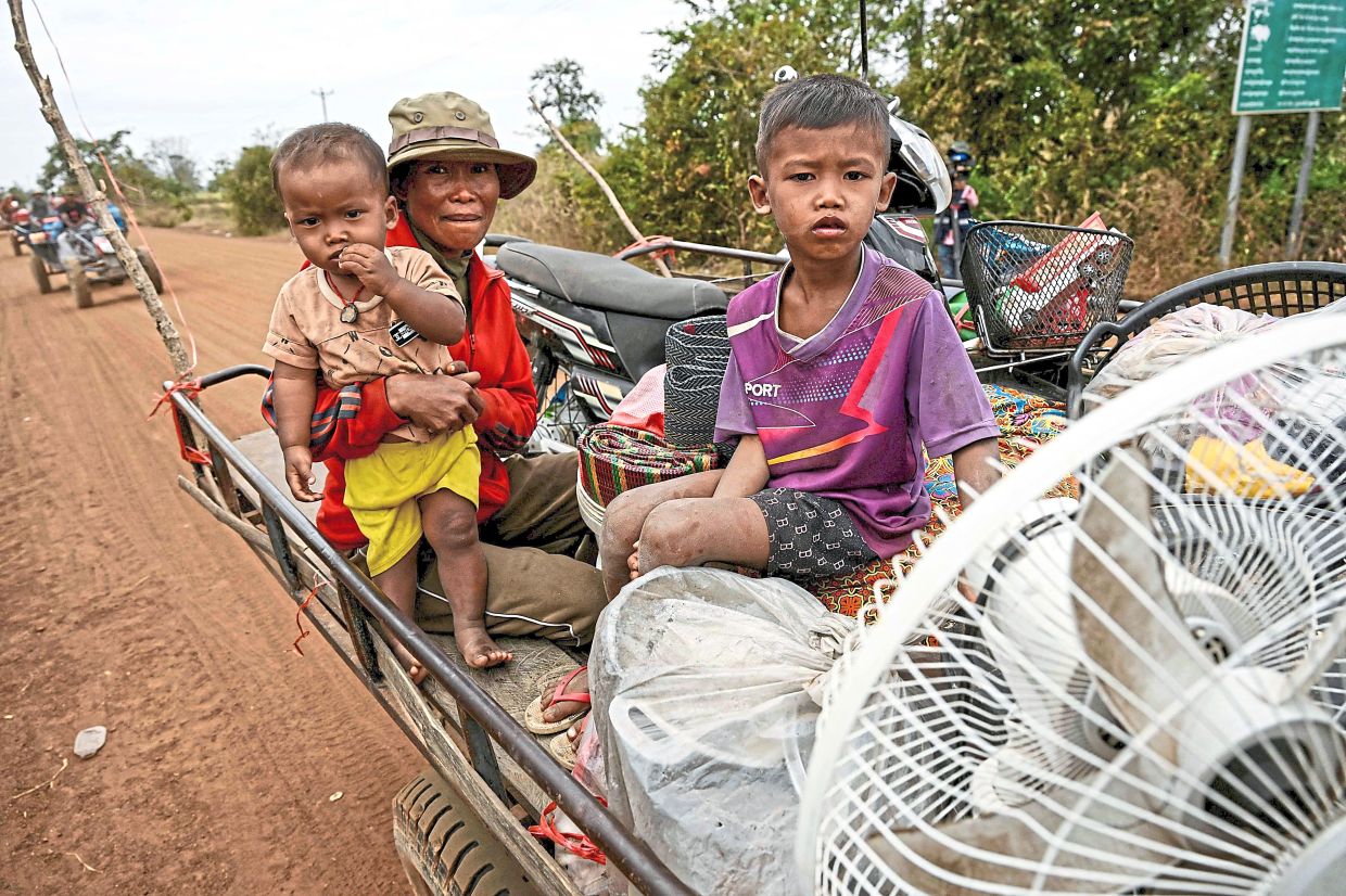 Plight of the people: Displaced residents evacuating in Cambodia’s Oddar Meanchey province.— AP