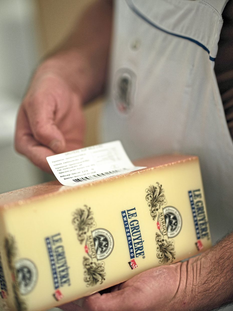 A label is affixed to a block of Gruyére at Margot Fromages in Yverdons-les-Bains, Switzerland, on Oct. 30, 2025. The company exports 4,500 tons of Gruyére to the United States, where buyers include Costo and Sam’s Club. (Lea Meienberg/The New York Times)