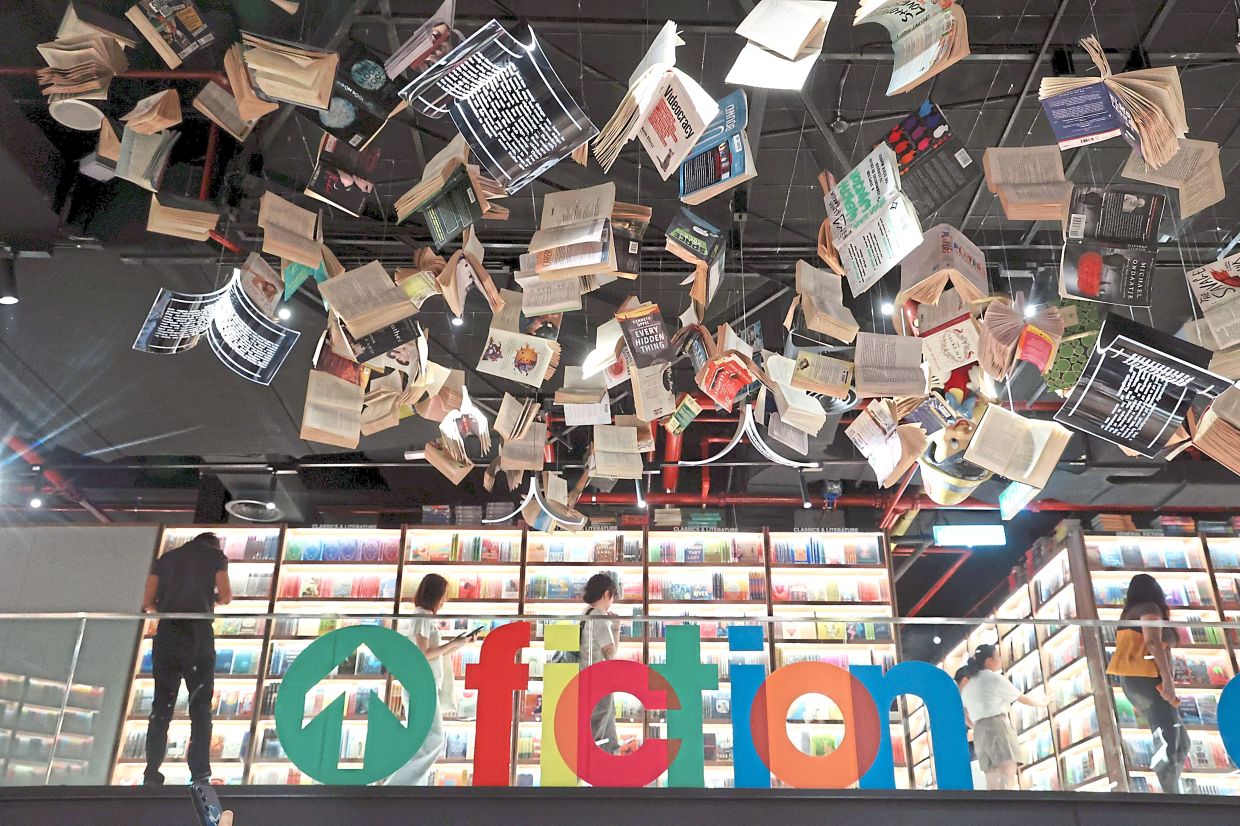 Visitors explore the Fiction section of The Library, BookXcess’s newly opened concept megastore. Photo: The Star/Art Chen